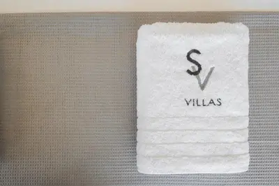 a pile of white towels with the word willias on them at Sky Sea View Villas in Chania Town