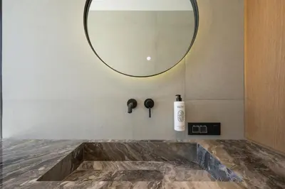 a bathroom with a sink and a mirror at Sky Sea View Villas in Chania Town