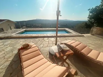 two lounge chairs sitting next to a swimming pool at Le Havre in Païdhokhórion