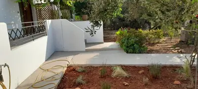 a white staircase leading to a garden with plants at Casa di Laino in Kounoupidhianá