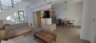 a living room with a tv and a table at Casa di Laino in Kounoupidhianá