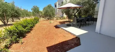 a patio with an umbrella and a table and chairs at Casa di Laino in Kounoupidhianá