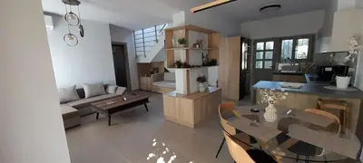 a living room with a couch and a table and chairs at Casa di Laino in Kounoupidhianá