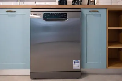 a stainless steel dishwasher in a kitchen with blue cabinets at Villa Akalli in Frangokastello