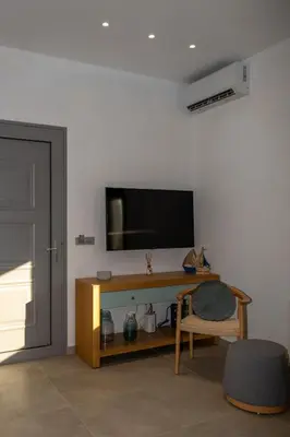 a living room with a television on a wall at Villa Akalli in Frangokastello