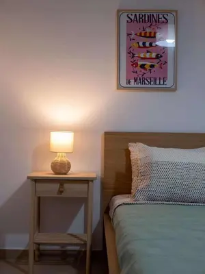 a bedroom with a bed and a table with a lamp at loupagio di mare in Plátanos