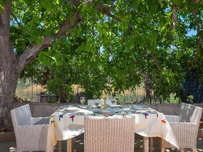 a table with chairs and a white tablecloth on it at loupagio di mare in Plátanos