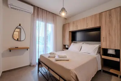 a bedroom with a large bed with towels on it at Heart Of Galatas Apartments Holidays In crete in Galatás