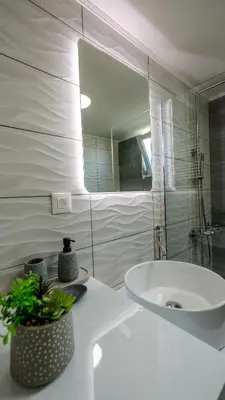 a white bathroom with a sink and a mirror at Heart Of Galatas Apartments Holidays In crete in Galatás