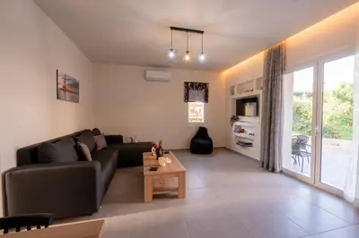 a living room with a couch and a table at Heart Of Galatas Apartments Holidays In crete in Galatás