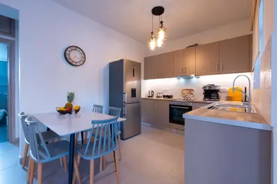 a kitchen with a table with chairs and a counter top at Heart Of Galatas Apartments Holidays In crete in Galatás