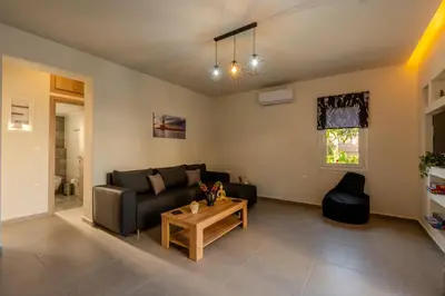 a living room with a couch and a table at Heart Of Galatas Apartments Holidays In crete in Galatás