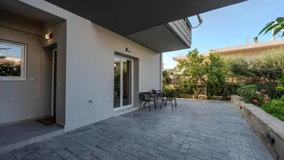 a patio with chairs and a table in a house at Heart Of Galatas Apartments Holidays In crete in Galatás