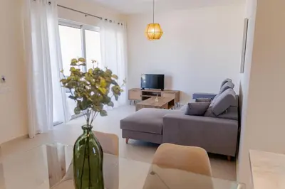 a living room with a couch and a vase on a table at Phaedrus Living Seaside Thalassa Cretan 101 in Módhion