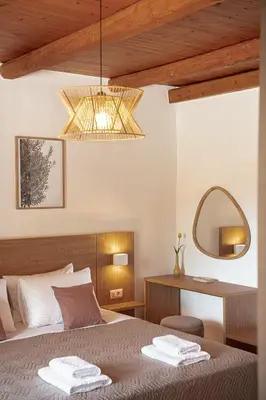 a bedroom with a bed and a mirror at Villa Staria in Kirtomádhos