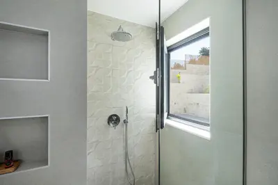 a shower with a glass door in a bathroom at Elithos Villa in Vryses
