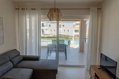 a living room with a couch and a table and a balcony at Phaedrus Living Seaside Thalassa Cretan D101 in Módhion