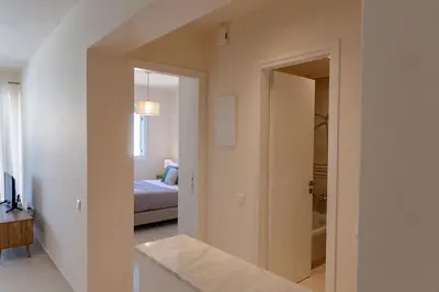 a room with a hallway with a bed and a mirror at Phaedrus Living Seaside Thalassa Cretan D101 in Módhion