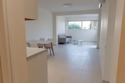 a kitchen and living room with a table and chairs at Phaedrus Living Seaside Thalassa Cretan D101 in Módhion