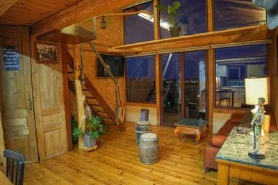 a living room with a staircase in a cabin at Casa Luma near Loutraki beach in Chania