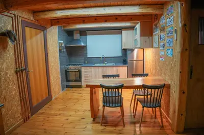 a kitchen with a wooden table and four chairs at Casa Luma near Loutraki beach in Chania
