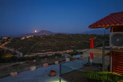 a view of a hill at night from a house at Casa Luma near Loutraki beach in Chania