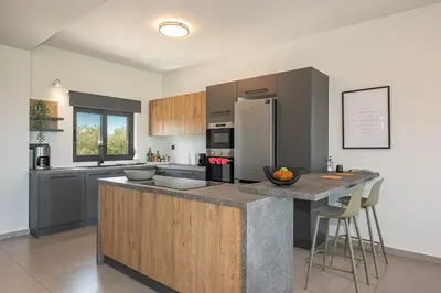 a kitchen with a large island in the middle at Villa Aurora 1- Getaway Bliss in Xamoudhokhórion