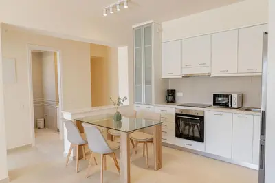 a kitchen and dining room with a glass table and chairs at Phaedrus Living Seaside Thalassa Cretan 102 in Módhion