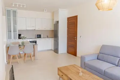 a living room with a couch and a table at Phaedrus Living Seaside Thalassa Cretan 102 in Módhion