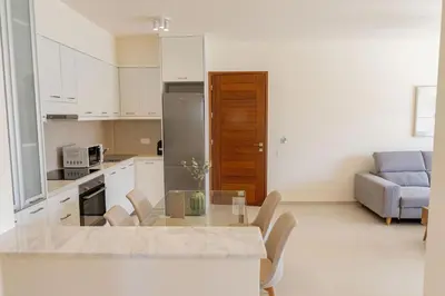 a kitchen and living room with a table and a couch at Phaedrus Living Seaside Thalassa Cretan 102 in Módhion