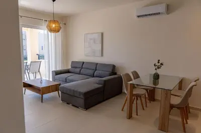 a living room with a couch and a table at Phaedrus Living Seaside Thalassa Cretan 103 in Módhion