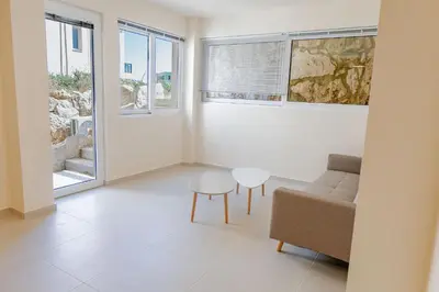 a living room with a couch and a table at Phaedrus Living Seaside Thalassa Cretan 103 in Módhion