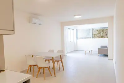 a kitchen and dining room with a table and chairs at Phaedrus Living Seaside Thalassa Cretan 103 in Módhion