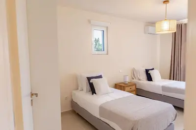 a bedroom with two beds and a window at Phaedrus Living Seaside Thalassa Cretan 103 in Módhion