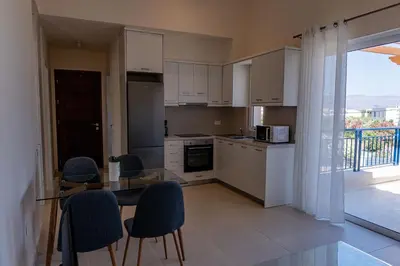a kitchen with a table and chairs and a window at Phaedrus Living Seaside Thalassa Cretan 201 in Módhion