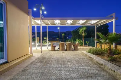 a pavilion outside of a building at night at Veranda Sul Mare in Gramvousá
