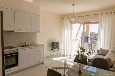 a kitchen and living room with a couch and a table at Phaedrus Living Seaside Thalassa Cretan 202 in Módhion