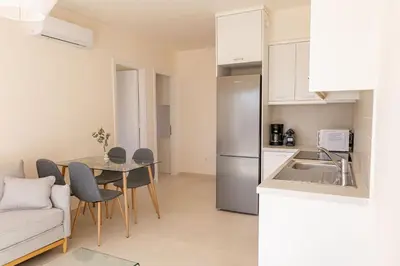 a kitchen and dining room with a table and a refrigerator at Phaedrus Living Seaside Thalassa Cretan 202 in Módhion