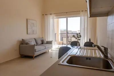 a kitchen and living room with a couch and a sink at Phaedrus Living Seaside Thalassa Cretan 203 in Módhion