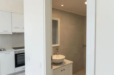 a kitchen with white cabinets and a sink at Phaedrus Living Seaside Thalassa Cretan 203 in Módhion