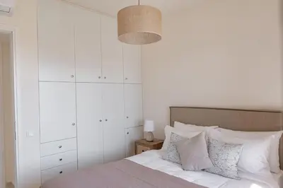 a bedroom with white walls and a bed with pillows at Phaedrus Living Seaside Thalassa Cretan 203 in Módhion