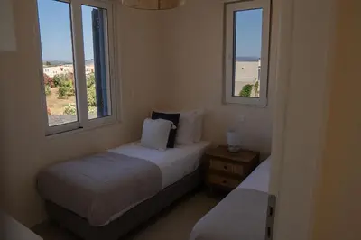 two beds in a room with two windows at Phaedrus Living Seaside Thalassa Cretan 203 in Módhion
