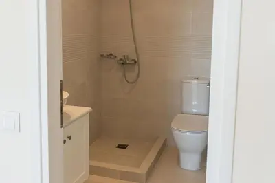 a bathroom with a white toilet and a shower at Phaedrus Living Seaside Thalassa Cretan 203 in Módhion