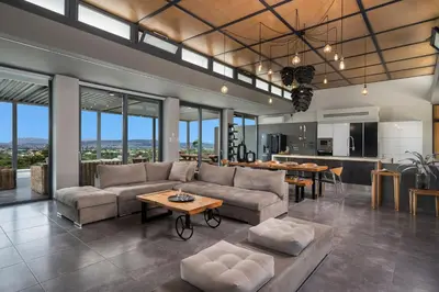 a living room with a couch and a table at Luxury Villa Olivenest with Private Heated Pool, Hot Tub & Sauna in Chania Town