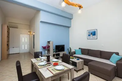 a living room with a couch and a table at Arnildi's View in Nopíyia
