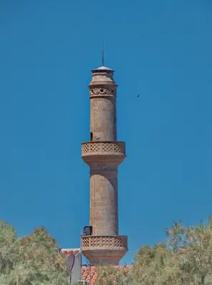 a tall brick lighthouse on top of a building at Bay view in town in Chania Town