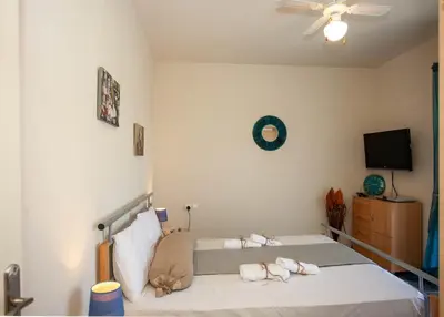 a bedroom with a bed with towels on it at Pyrgos Spring pool apartment in Maleme