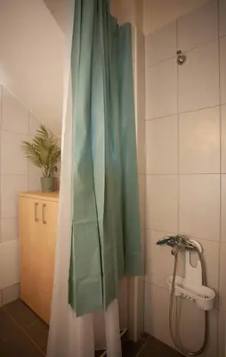 a shower curtain in a bathroom with a sink at Pyrgos Spring pool apartment in Maleme