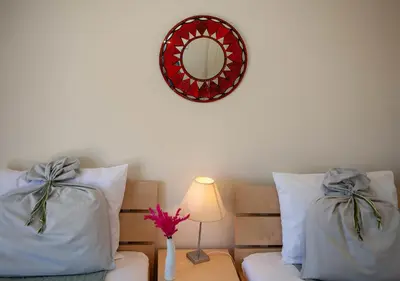 a bedroom with two beds and a mirror on the wall at Pyrgos Spring pool apartment in Maleme