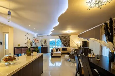 a living room with a kitchen and a living room with a couch at SI-EL Villa in Vryses